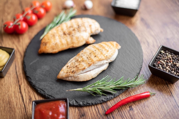 grilled chicken fillet on wooden background