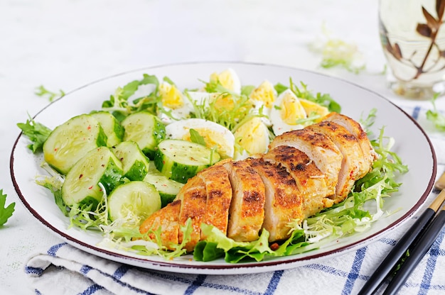 Grilled chicken meat and boiled eggs and fresh cucumber salad Healthy keto ketogenic lunch Roasted chicken breast fillet and fresh vegetable salad