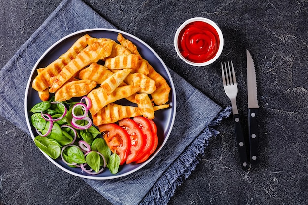 Grilled chicken strips on a plate with vegetables