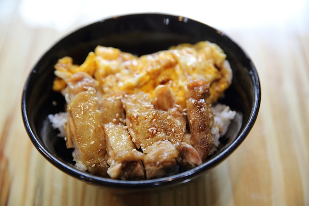 Grilled Chicken teriyaki rice and egg on wood background