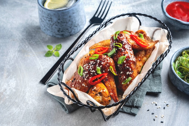 Grilled chicken wings in a metal basket