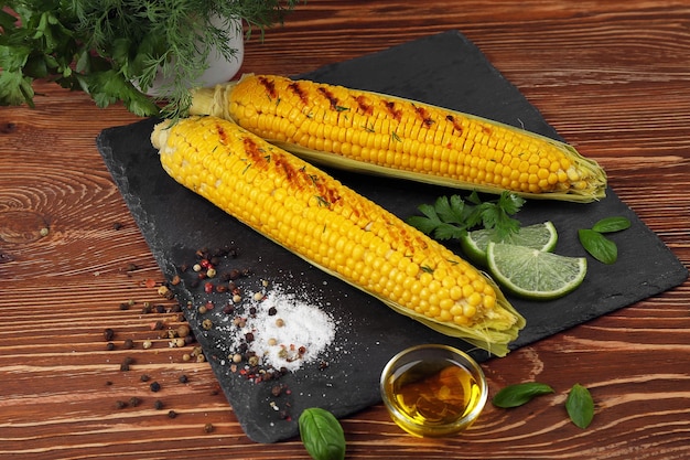 Grilled corns with ingredients on cutting board