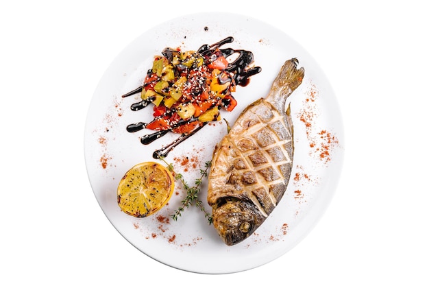 Grilled dorado fish with baked vegetables