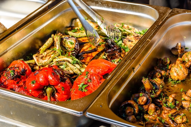 Grilled eggplants and bell peppers in a metal tray