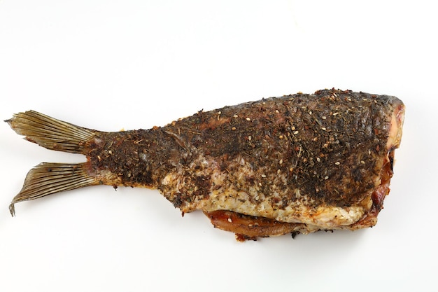 Grilled fish on the table Baked carp isolated on white