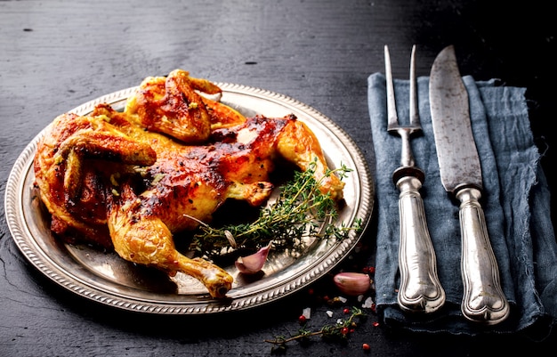 Grilled fried roast Chicken Tabaka with thyme and garlic