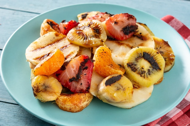 Grilled fruit on a blue plate and white