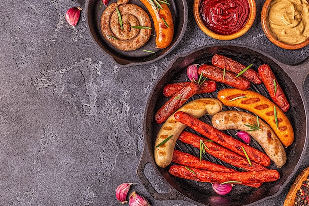 Grilled homemade sausages in a pan, top view.