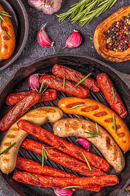 Grilled homemade sausages in a pan, top view.