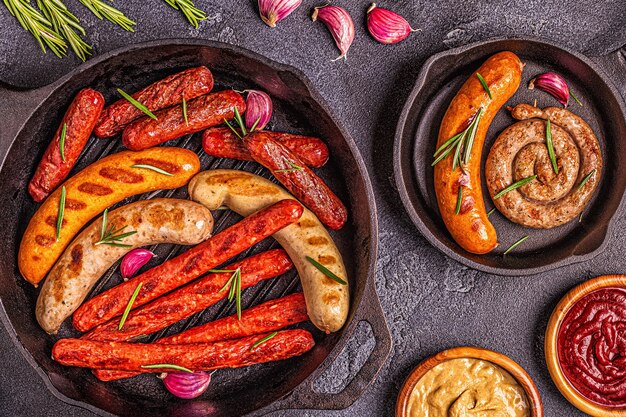 Grilled homemade sausages in a pan, top view.