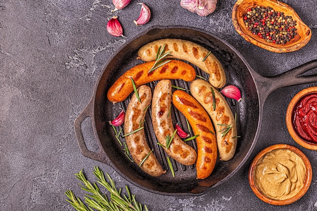 Grilled homemade sausages in a pan