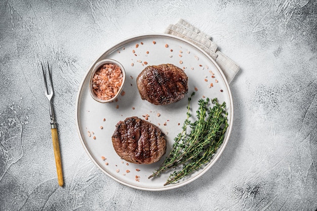 Grilled meat Fillet Mignon steaks from beef tenderloin. White background. Top view.