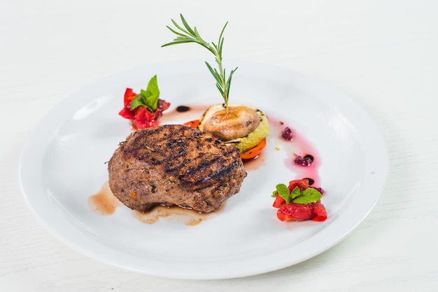 Grilled meat steak dish with fruits garnish