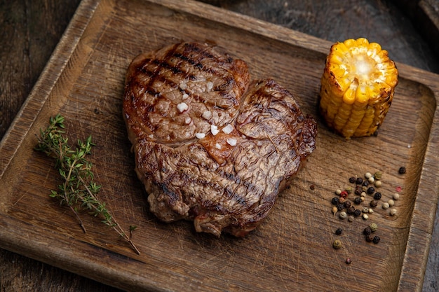 grilled meat steak on a wooden board with spices in a premium restaurant