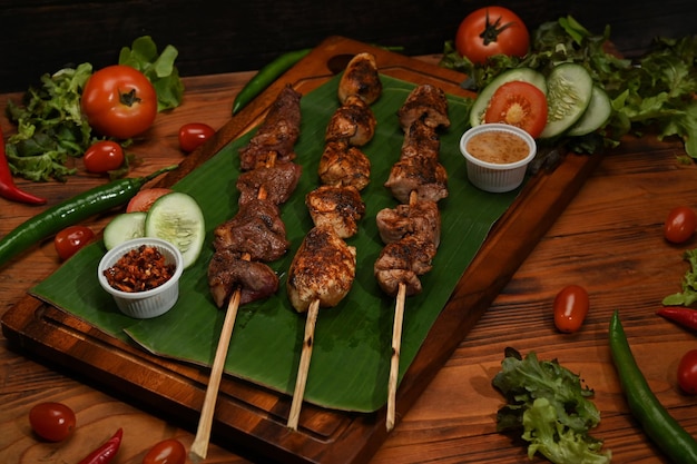 Grilled meat with Sichuan pepper on wood board and ingredients Mala Sichuan pepper Chinese spices