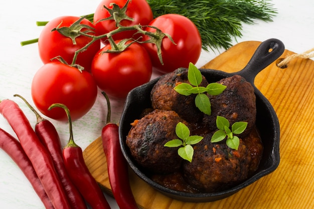 Grilled meatballs served in a skillet