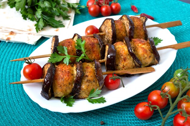 Grilled meatballs with eggplant on skewers