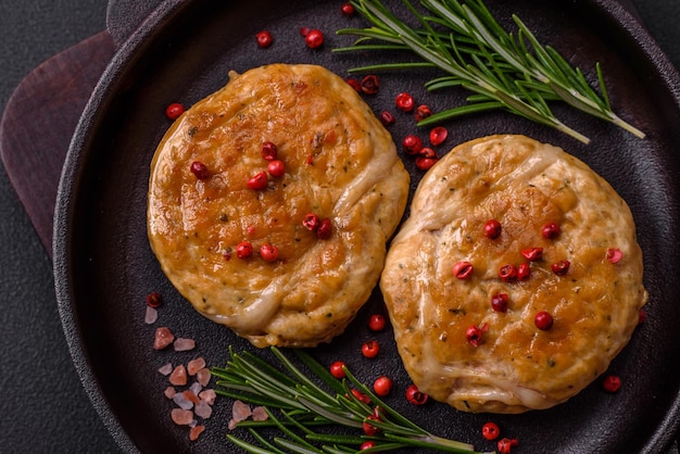 Grilled meatballs with spices and herbs or crepinette on a dark concrete background