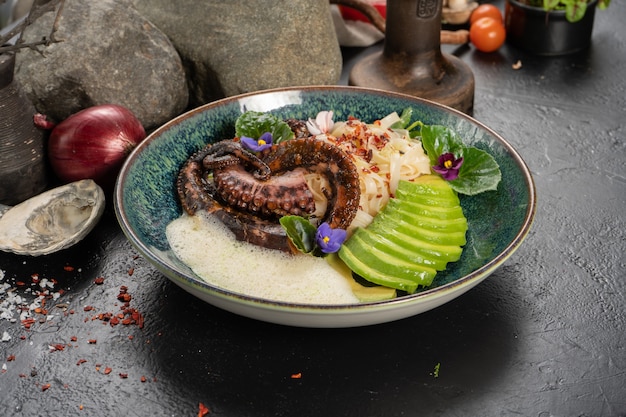 Grilled octopus with udon noodles and fresh avocado