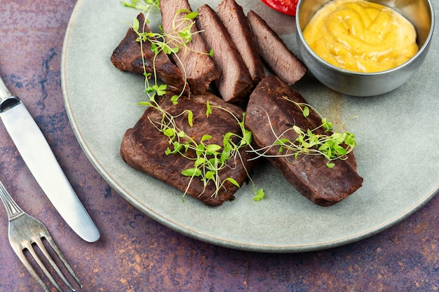 Grilled ostrich steak with sauce