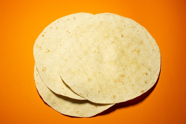 Grilled Pita or tortilla on the orange background. Mexican food.