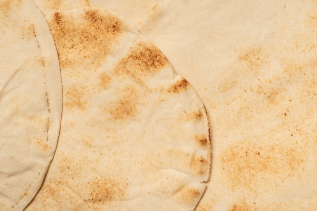 Grilled pitta bread isolated on white wall. Top view.