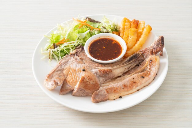 grilled pork chop steak with Thai spicy dipping sauce or Jaew sauce - fusion food style