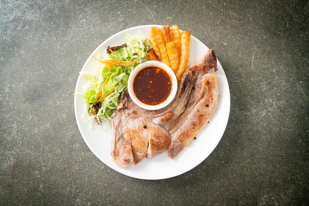 grilled pork chop steak with Thai spicy dipping sauce or Jaew sauce - fusion food style