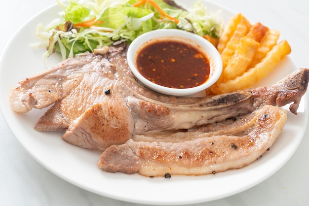 grilled pork chop steak with Thai spicy dipping sauce or Jaew sauce - fusion food style