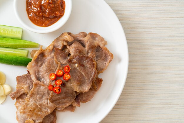 grilled pork neck sliced on plate in Asian style