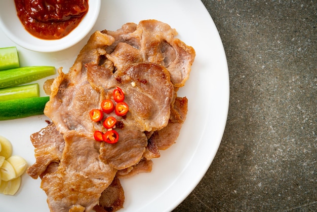 grilled pork neck sliced on plate in Asian style