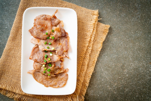 grilled pork neck sliced on plate in Asian style