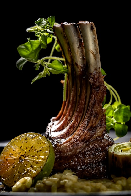 Grilled pork ribs and various vegetables on a chopping wood. High quality photo