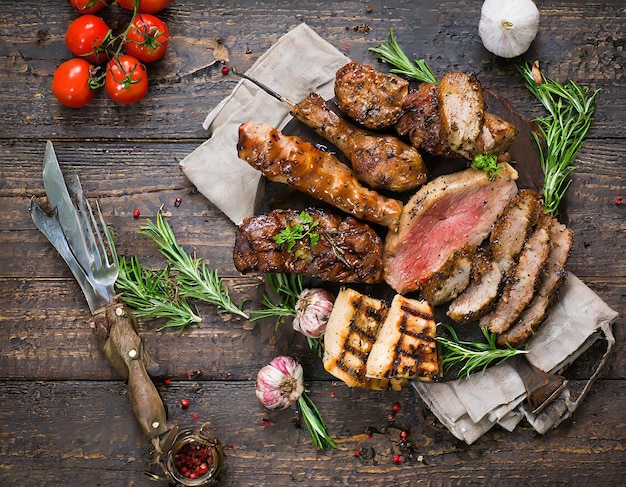 Photo grilled pork ribs with spices and herbs on wooden background top views