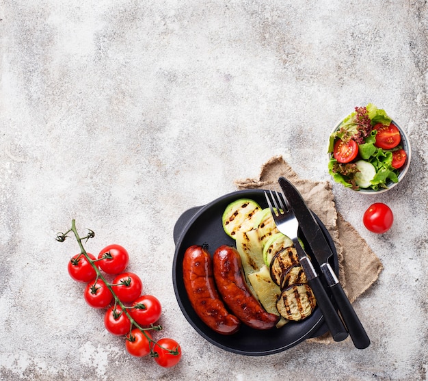 Grilled pork sausages and vegetables