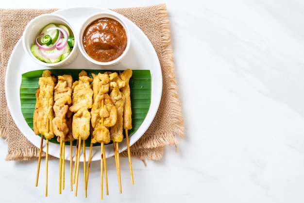 Grilled pork served with peanut sauce or sweet and sour sauce