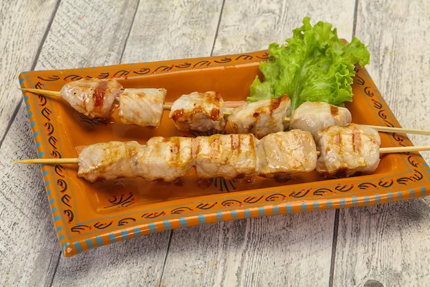 Grilled pork skewer served salad