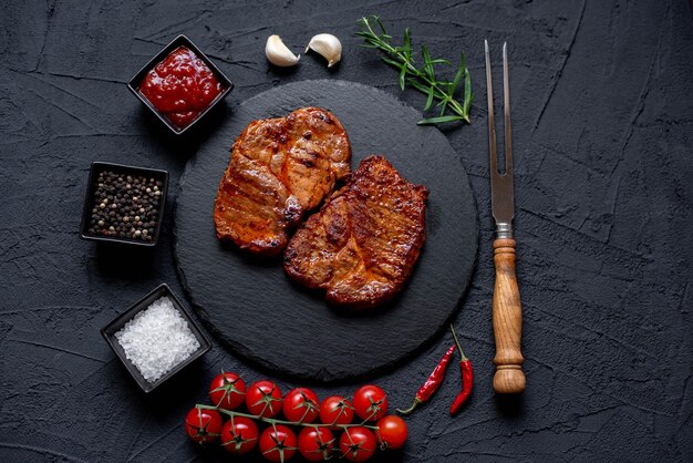 grilled pork steaks on stone background