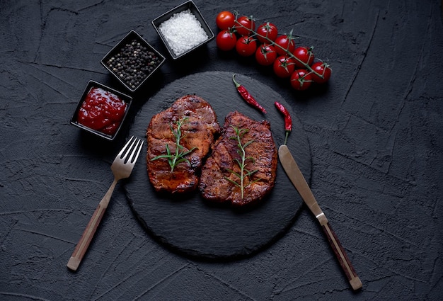 grilled pork steaks on stone background