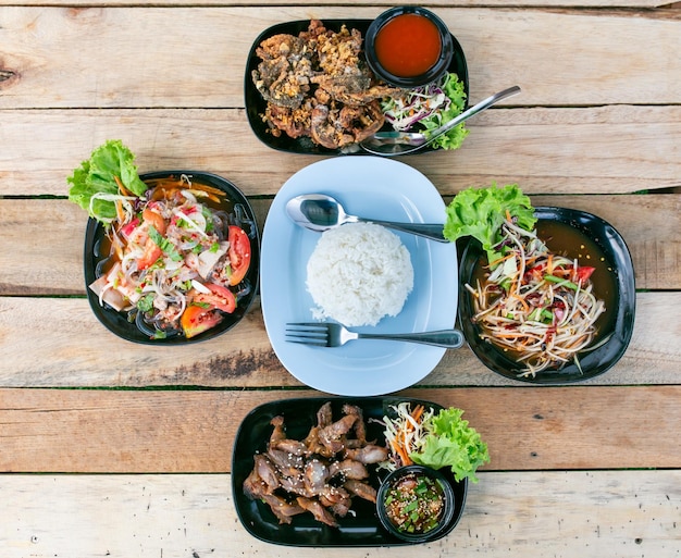 Grilled pork with sweet and sour sauce Thai papaya salad fried frog and Thai spicy mixed salad