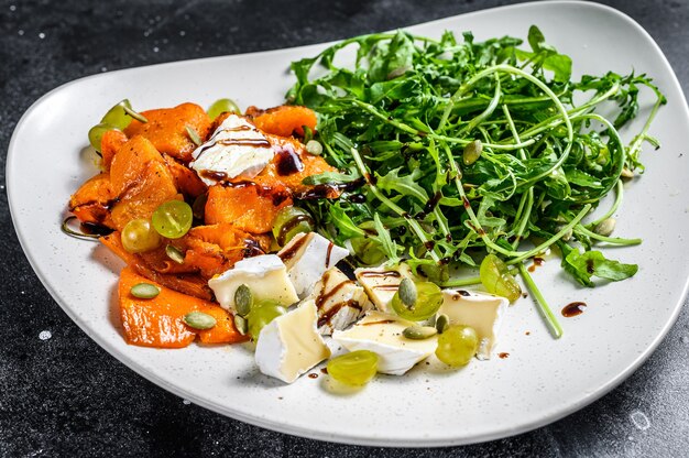 Grilled pumpkin warm salad with arugula, walnuts, and brie cheese