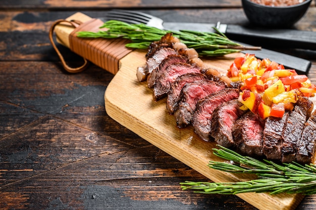 Grilled ramp cap steak on a cutting board