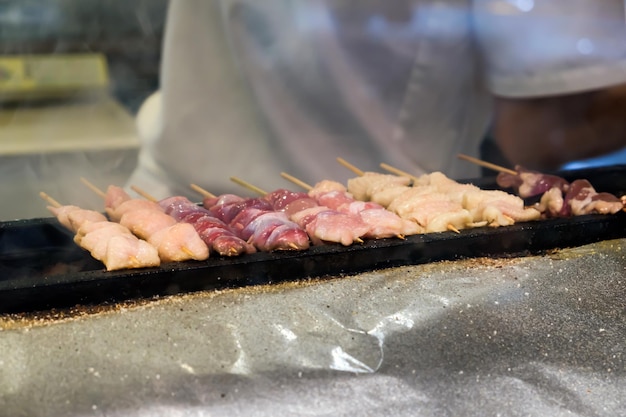 Grilled raw porkbeef and chicken on stove grill in street food