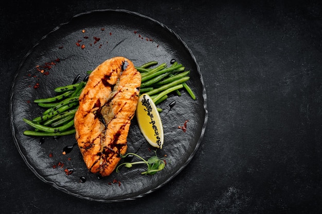 Grilled redfish steak with green beans and lemon