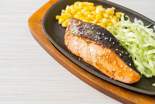 Grilled salmon fillet steak on hot plate