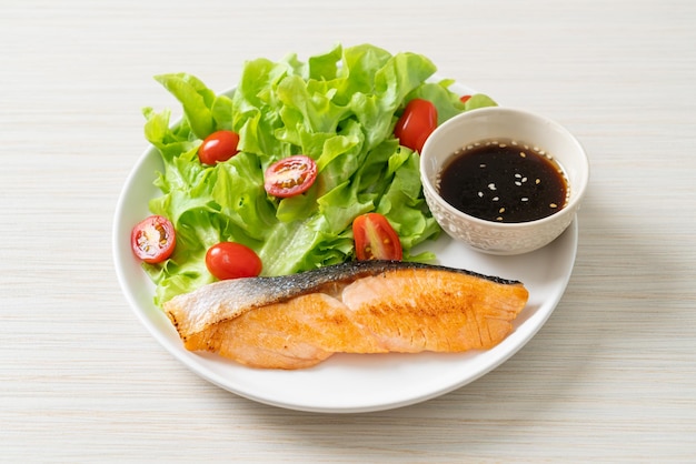 Grilled salmon fillet steak with salad