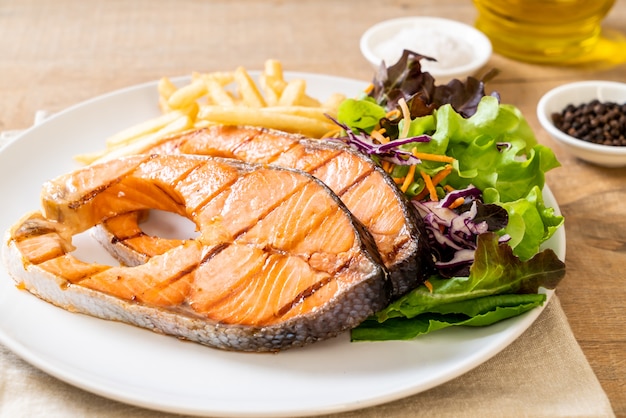 grilled salmon steak fillet with french fries