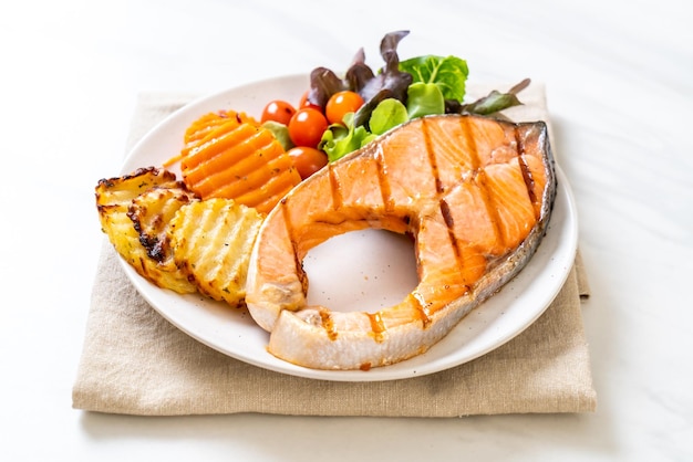 Grilled salmon steak fillet with vegetable and french fries