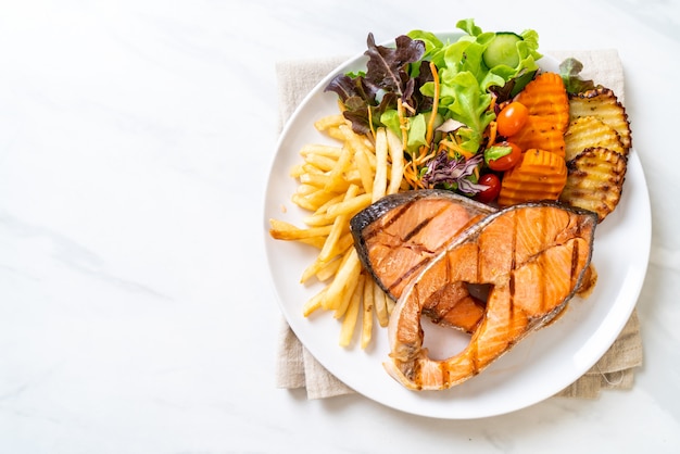 grilled salmon steak fillet with vegetable and french fries