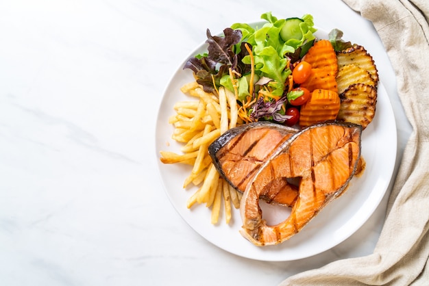 grilled salmon steak fillet with vegetable and french fries